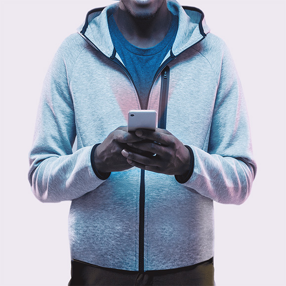 Poster of a man wearing a teal zip-up hoodie holding a smartphone