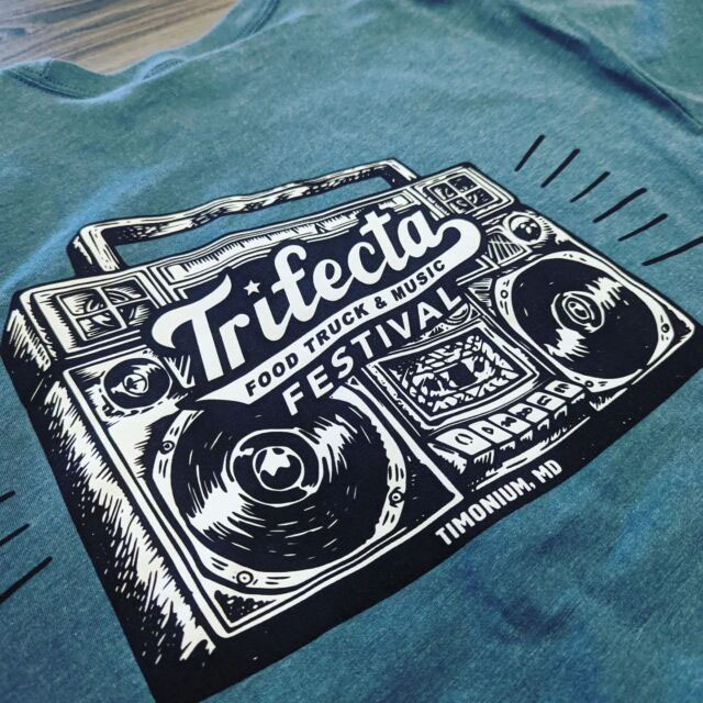 Detailed shot of a boom box inspired digital print on a teal shirt