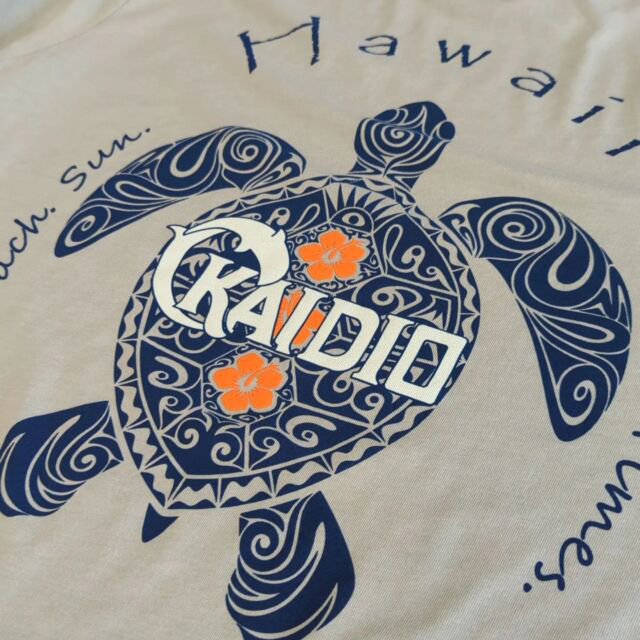 Detail shot of a turtle digital print design on a cream shirt